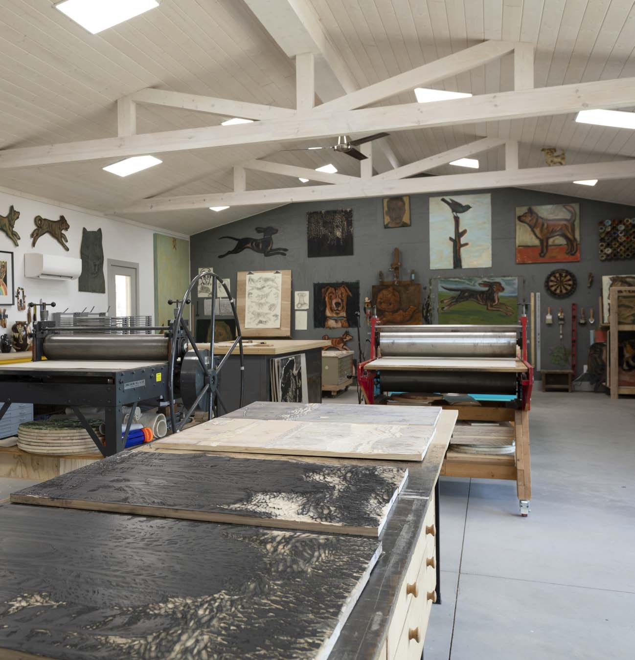 Kent's signature dogs run and play along the walls of his spacious new studio.