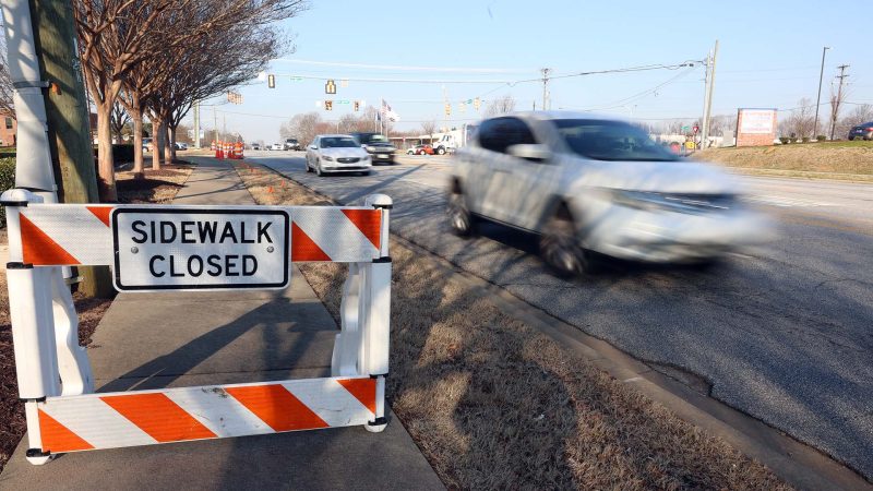 Cars travel on Woodruff Road Monday morning.